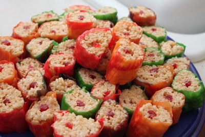 A plate full of  sliced rice crispies wrapped in a fruit roll-ups. 