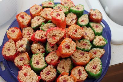 A plate full of  sliced rice crispies wrapped in a fruit roll-ups. 