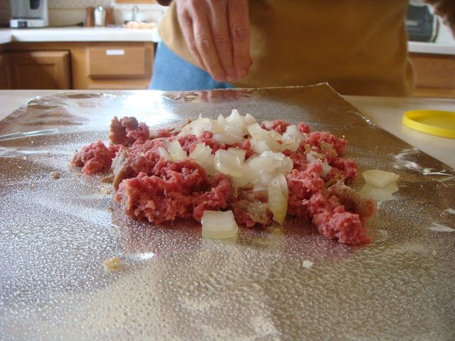 Grind meat with white onion in a foil.