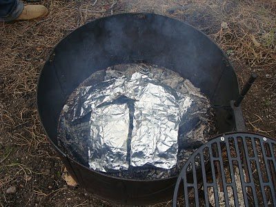 Grind meat with white onion, potatoes, and carrot sealed in a foil tossed in hot coal.