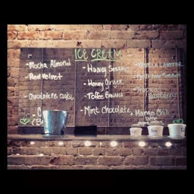 A mirror with many writings of the different flavors of ice cream. 