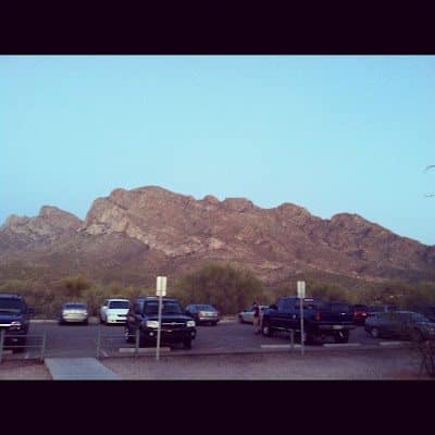 A crowded parking lot filled with numerous cars parked closely together.