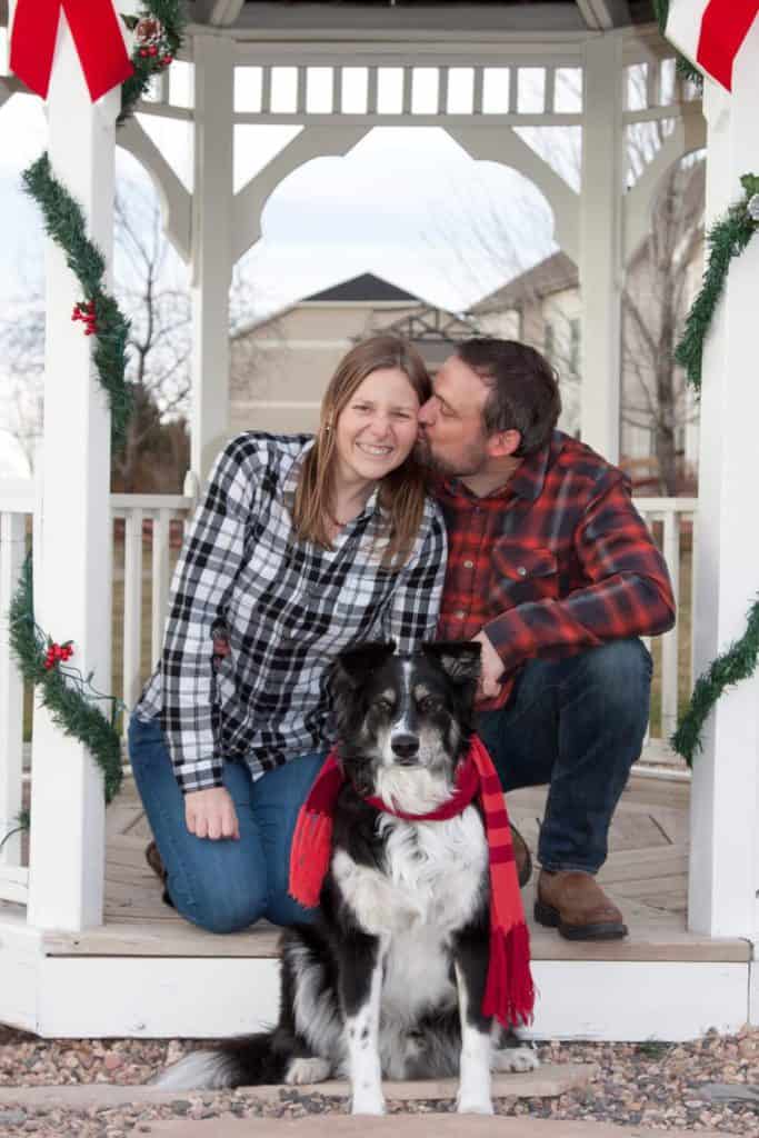 Photo of Becky and her husband sitting on a porch with a dog in her Holiday Engagement - This is our proposal story.