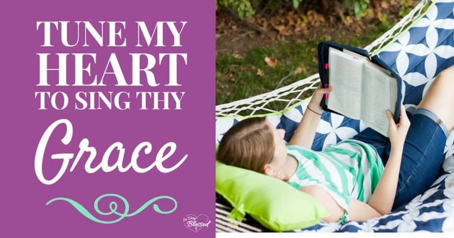 A photo of Becky in a hammock holding and reading her Bible, with a text overlay that reads as 'Tune My Heart To Sing Thy Grace': So Very Blessed.