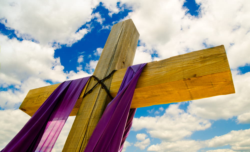 Purple fabric draped over cross for Lent