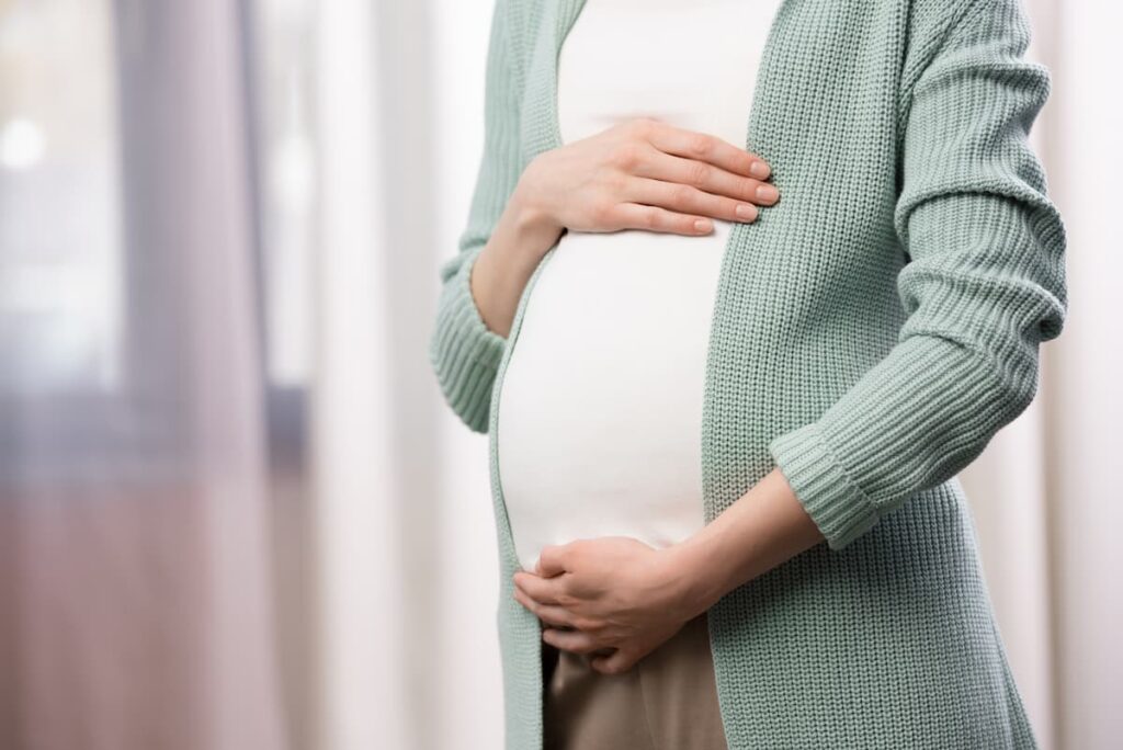 pregnant mom with hands around her belly