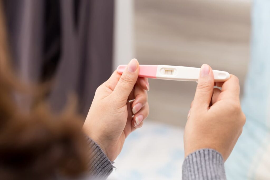 Prayers to Get Pregnant - Woman holding pregnancy test in her hands