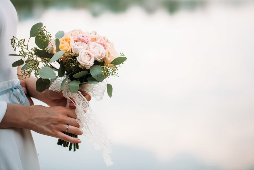 Bible Verses on Wives - woman holding a wedding bouquet of flowers
