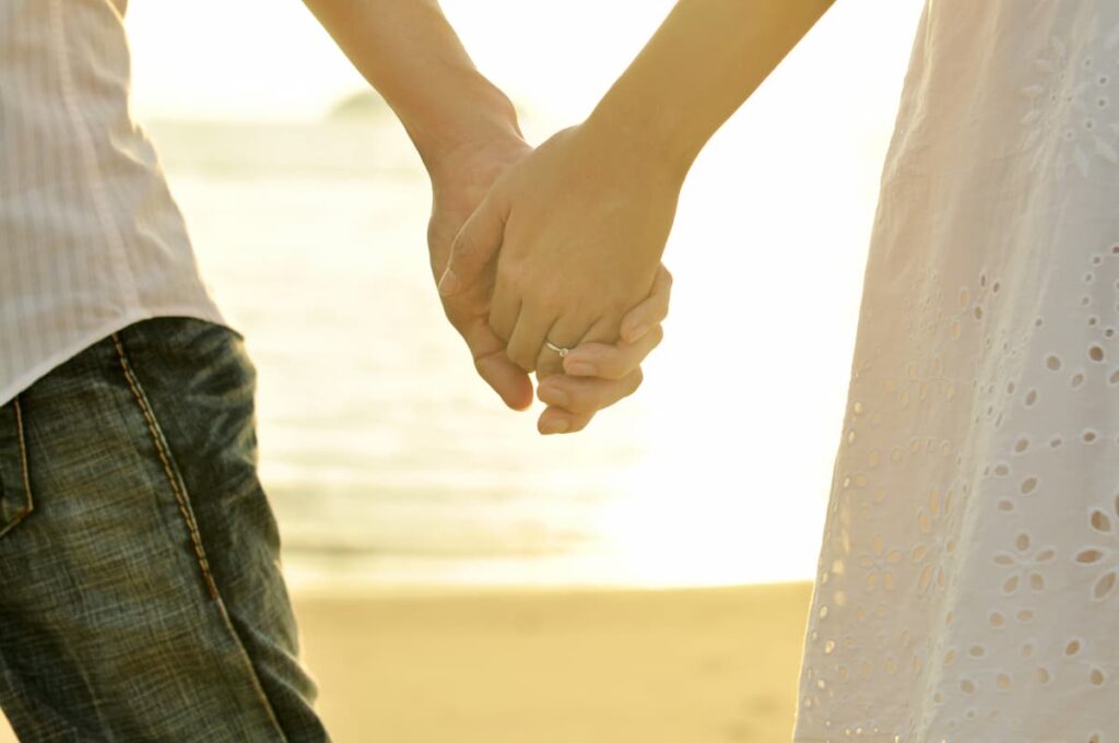 Bible Verses on Husbands - husband and wife holding hands on the beach