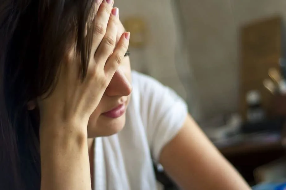 Bible Verses on Stress -  woman stressed with her head in her hands