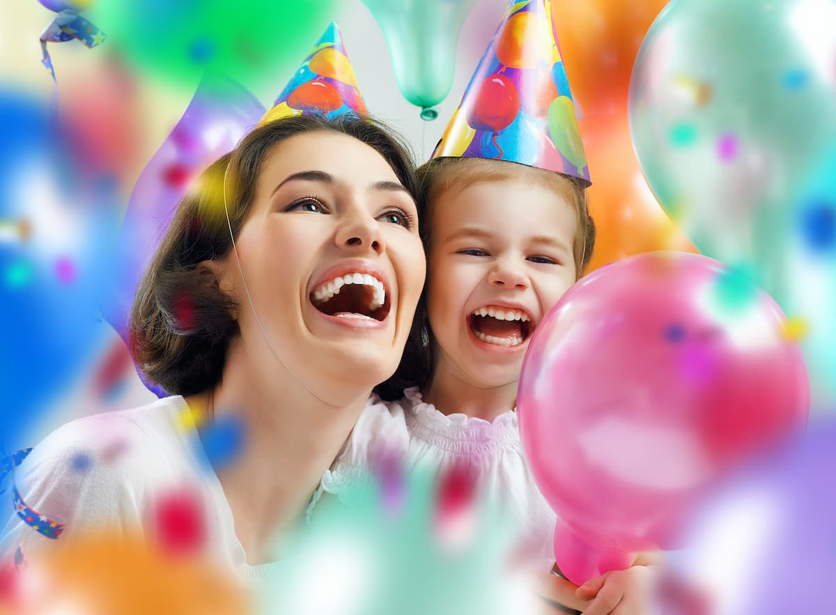Mother & Daughter celebrating birthday with balloons and confetti