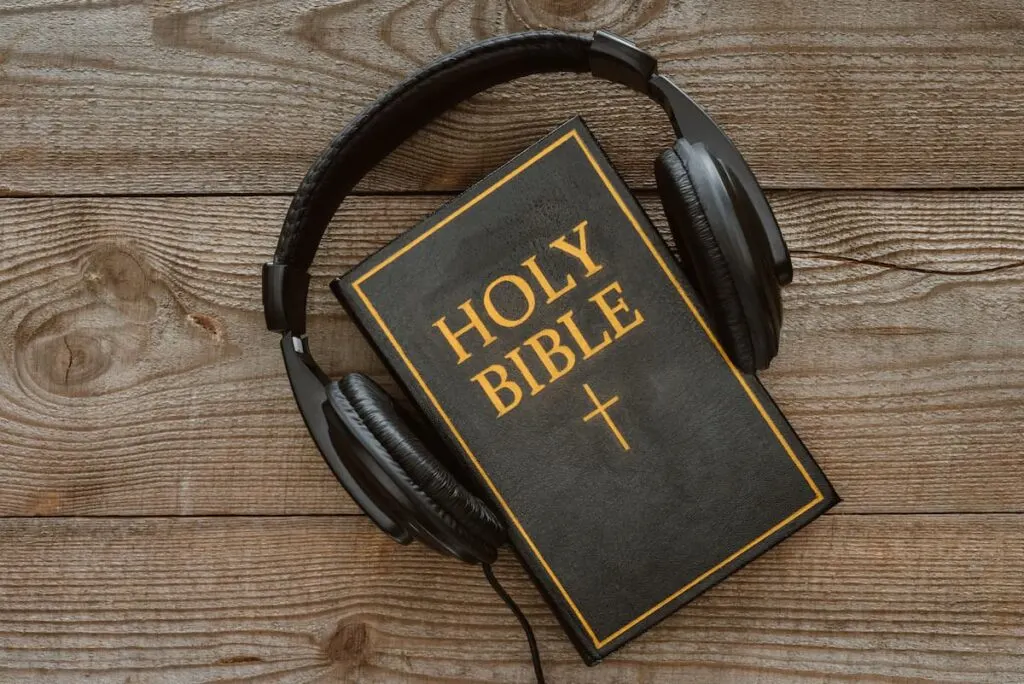 Black Bible with Black Large Headphones Around It