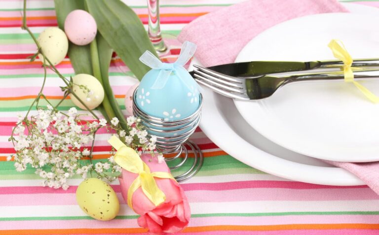 Easter table setting with striped tablecloth and easter eggs