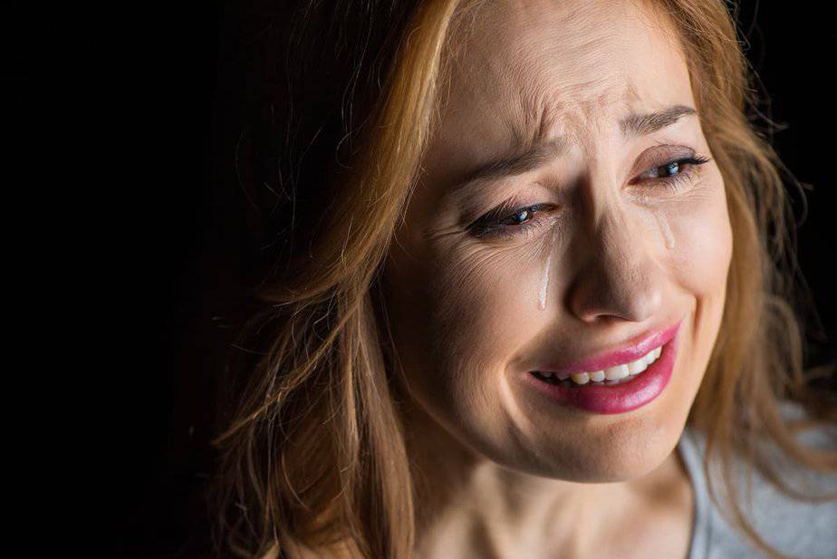 Woman crying with tears streaming down her face for 37 Bible verses about tears and crying