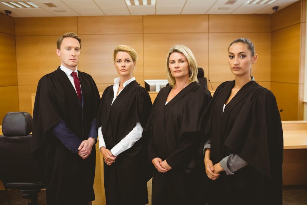Prayers for Lawyers - four serious judges standing while wearing robes