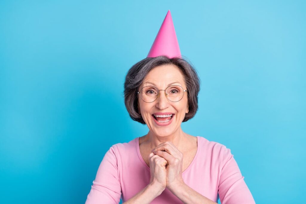 Happy birthday prayer to my mother in law - Photo of happy excited cheerful mature woman hold hands in anticipation