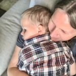 Tired mom holding a sleepy young child