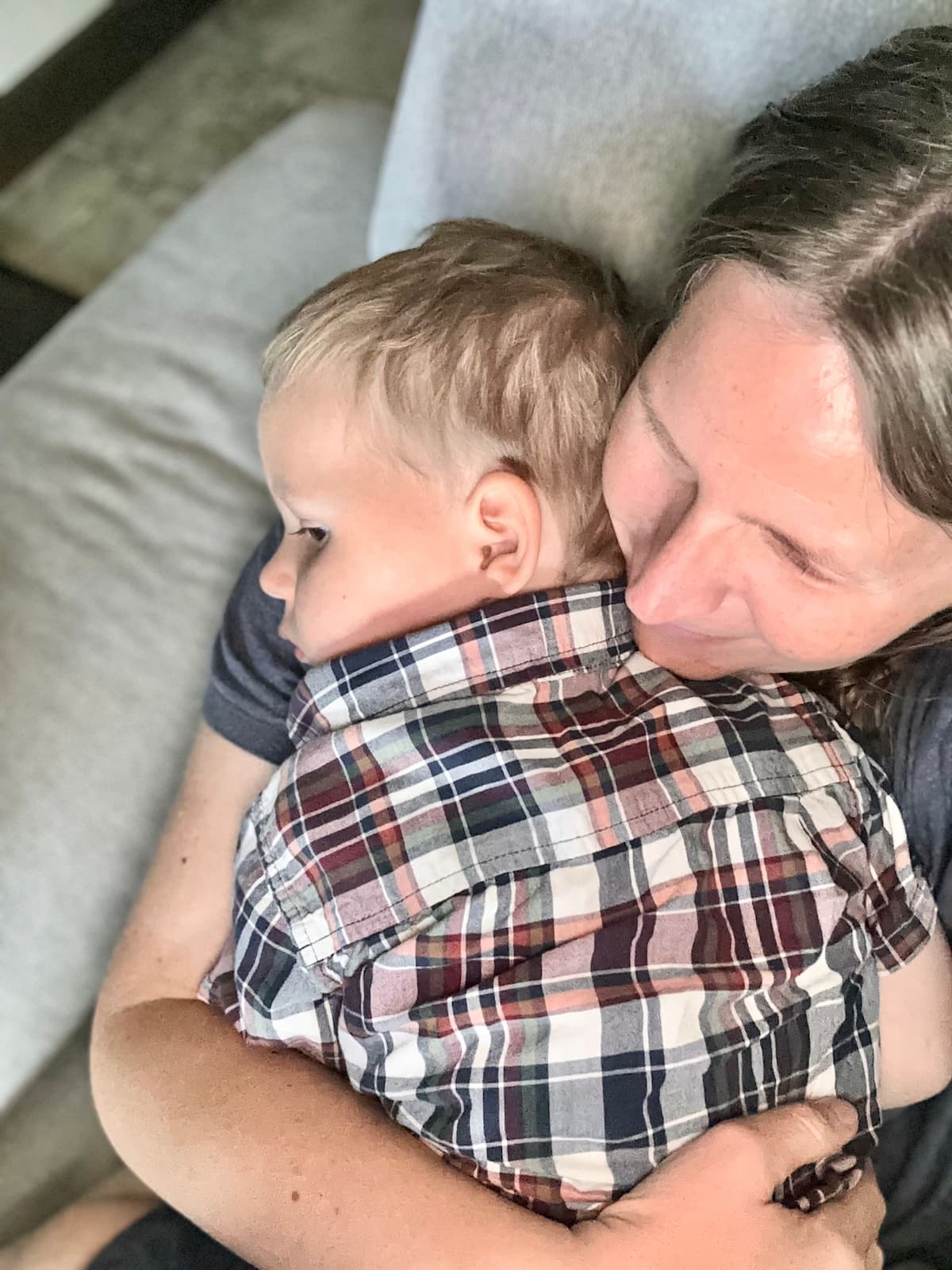 Tired mom holding a sleepy young child